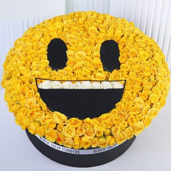yellow-rose-happy-smiley-box Yellow spray roses arranged in a smiling emoji-style floral box with white rose detailing.