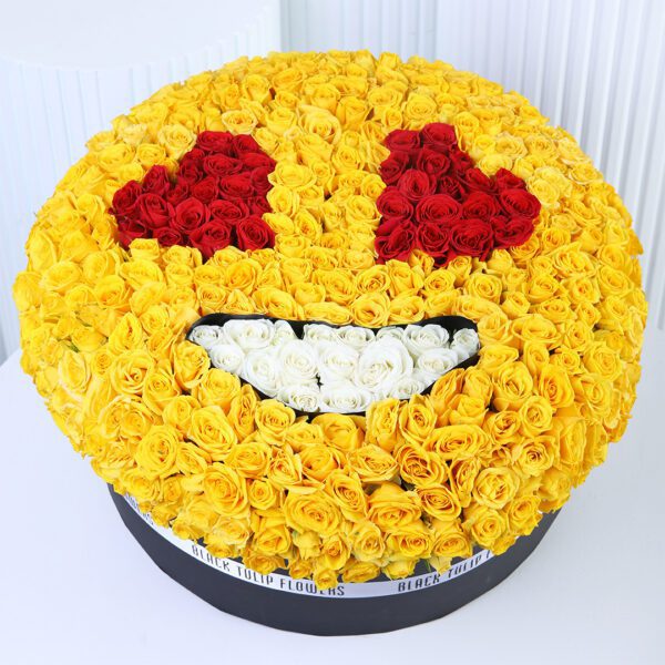 yellow-spray-rose-smiley-box. Yellow spray roses arranged in a smiley-face floral box design with red and white rose detailing.