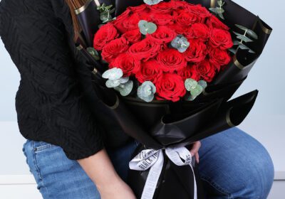 20 red roses bouquet with eucalyptus in a black wrap