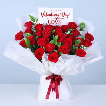 25 red roses bouquet wrapped in white paper with ribbon.