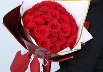 Bouquet of 30 red roses in white and maroon wrapping style with gold edging, finished with a ribbon.
