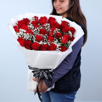 Valentine’s Day red rose bouquet with baby’s breath in white wrapping