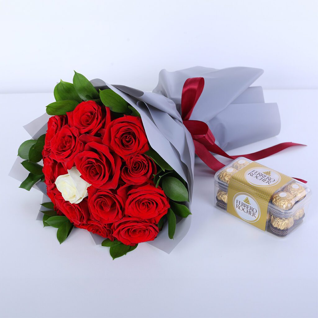 Red rose bouquet with green foliage and luxury wrapping, paired with ferrero chocolates