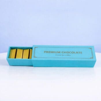 Elegant turquoise half opend premium chocolate box with smooth, rich chocolates inside