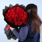 red-rose-bouquet-in-black-wrap