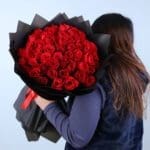 red-rose-bouquet-in-black-wrap