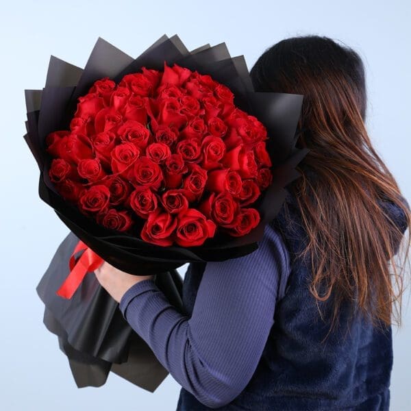 red-rose-bouquet-in-black-wrap 50 red rose bouquet in black wrap, finished with a red ribbon.