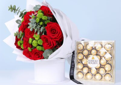 Bouquet of red roses with green chrysanthemums and eucalyptus in white wrap, finished with a Ferrero Rocher box