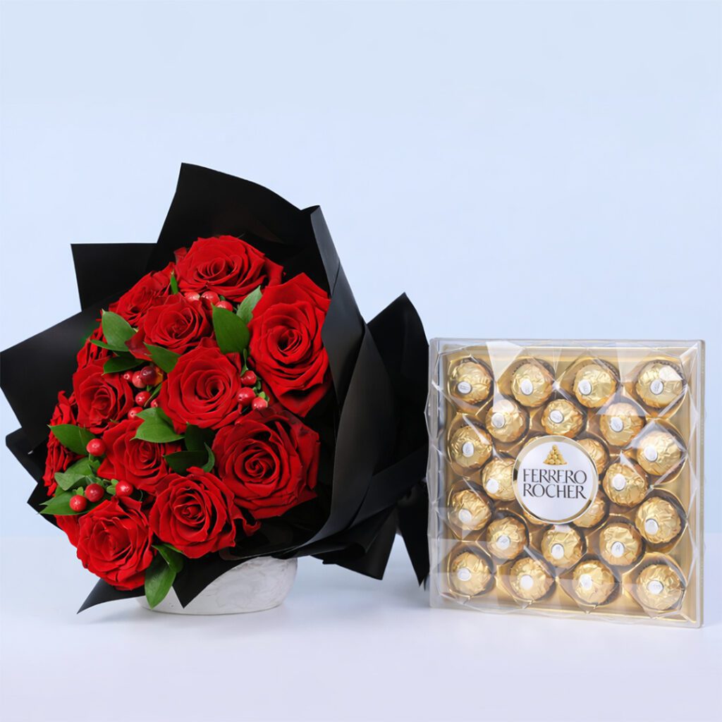 Red roses with green accents in elegant black wrapping, fwith a Ferrero Rocher chocolate box
