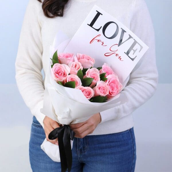 10-light-pink-roses-blush-4-u-bouquet-vday. 10 light pink roses with ruscus in a white wrap with note 'Love For You'