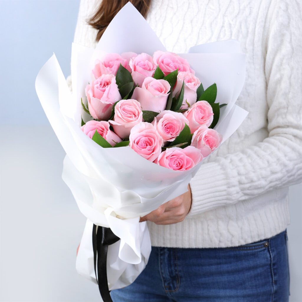 12 light pink roses with rusucs in an off white luxury wrap