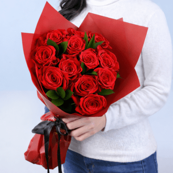 12 red roses with ruscus in a red luxury wrap