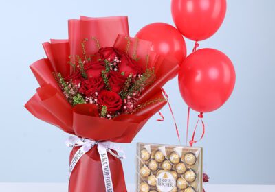 Red roses with fillers in red wrap, with a Ferrero Rocher chocolate box and 3 red balloons