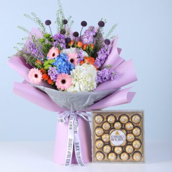 Cheerful Bloom Celebration Box with Ferrero featuring mixed vibrant and pastel flowers with chocolates arranged in a modern gift box