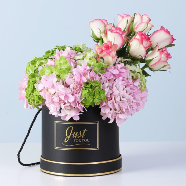 Classic Luxe Floral Box featuring green and pink hydrangeas with pink roses arranged in a sleek black box for gifting