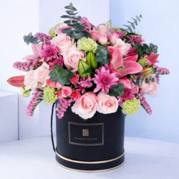 Premium round box filled with fresh seasonal flowers arranged in a vibrant and balanced style.