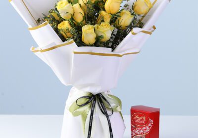 Exquisite Yellow Roses Lindt Combo with yellow roses, millet berry fillers, and Lindt chocolates wrapped elegantly for gifting