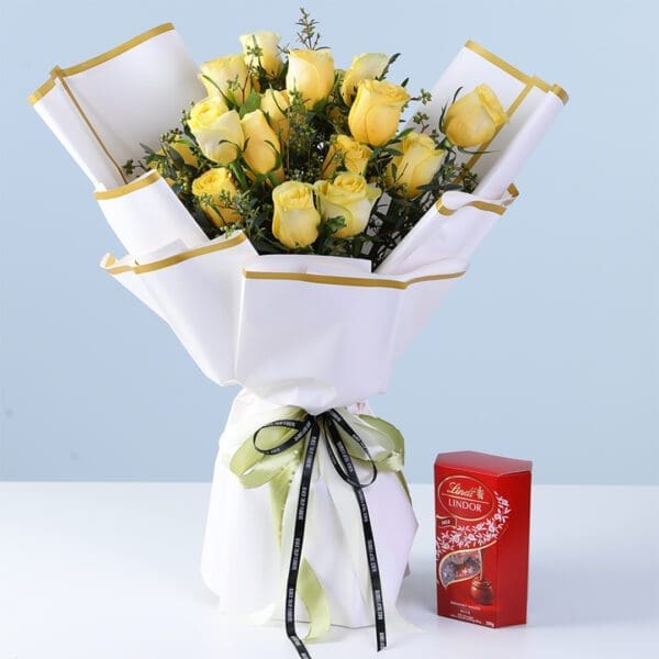 exquisite-yellow-roses-lindt-combo Exquisite Yellow Roses Lindt Combo with yellow roses, millet berry fillers, and Lindt chocolates wrapped elegantly for gifting