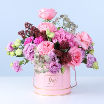 Mixed Pastel Flower Box with pink roses, hydrangea, lisianthus, carnations, and seasonal flowers arranged in a pink hatbox