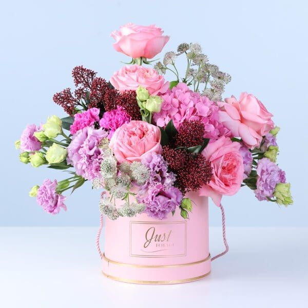 mixed-pastel-flower-box Mixed Pastel Flower Box with pink roses, hydrangea, lisianthus, carnations, and seasonal flowers arranged in a pink hatbox
