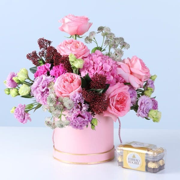 mixed-pastel-flower-box-with-ferrero-rocher-16-pcs Mixed Pastel Flower Box with Ferrero featuring pink roses, hydrangea, lisianthus, carnations, and chocolates arranged in a pink hatbox for gifting