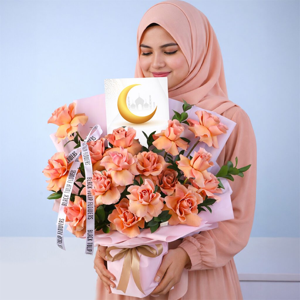 Luxury hand-tied bouquet of orange roses with single Ruscus, elegantly arranged