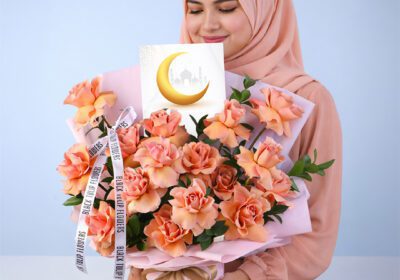 Luxury hand-tied bouquet of orange roses with single Ruscus, elegantly arranged