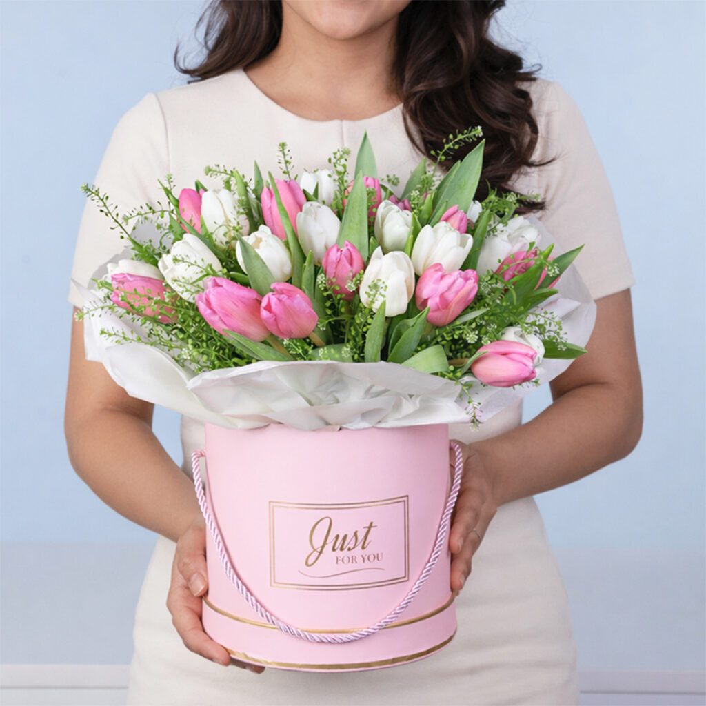 Classic arrangement of pink and white tulips in a premium box with greenery