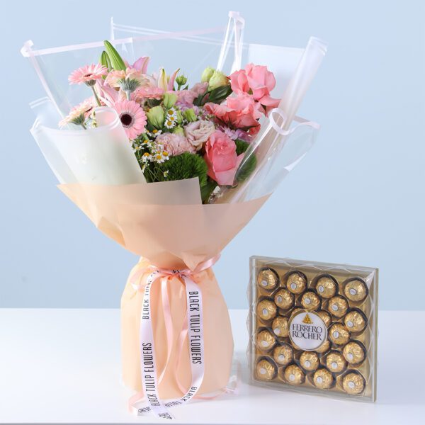 Pastel Pink Harmony Bouquet with Ferrero featuring pink gerberas, roses, lilies, hydrangea, and 24 Ferrero chocolates arranged for gifting