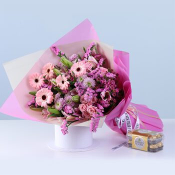 Pink Harmony Bouquet Ferrero 16 Pcs featuring mixed flowers like gerberas, lilies, baby roses, and chrysanthemums arranged with chocolates for gifting