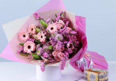 Pink Harmony Bouquet Ferrero 16 Pcs featuring mixed flowers like gerberas, lilies, baby roses, and chrysanthemums arranged with chocolates for gifting