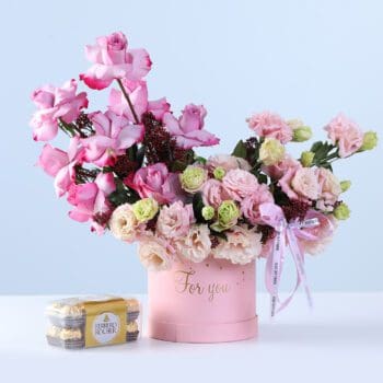 Luxury Floral Box Ferrero 16 Pcs Combo featuring pink roses, lisianthus, purple roses, skimmia, and Ferrero chocolates arranged in a pastel hatbox