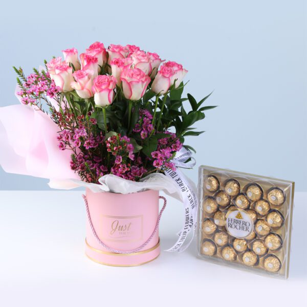 Rosy Charm Floral Box with Ferrero featuring double pink roses, wax flowers, greenery, and chocolates arranged in a pink luxury box for gifting