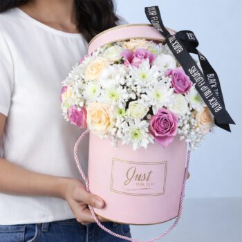 Royal Peach Lavender Flower Box featuring purple roses, peach roses, lisianthus, chrysanthemums, and gypsophila arranged in a round pink box