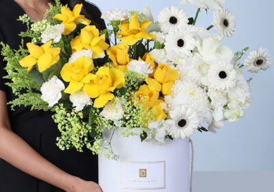 Sunlit Elegance Mixed Flower Box featuring yellow roses, white roses, carnations, gerberas, orchids, and fillers arranged beautifully for gifting and décor