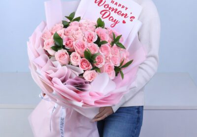 Soft pink rose bouquet with ruscus greenery arranged as an elegant flower gift