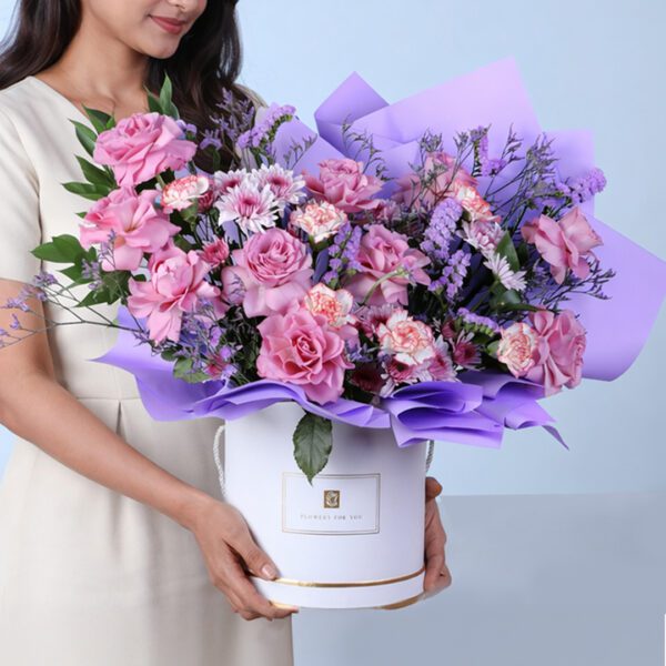 Violet Garden Floral Box featuring purple roses, bi-color carnations, chrysanthemums, and filler flowers arranged in an elegant luxury bouquet