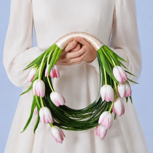 blush-tulip-bridal-bouquet Blush Tulip Bridal Bouquet featuring 15 light pink tulips with steel grass accents arranged in a minimalist bridal design