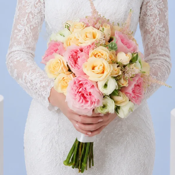 dreamy-blush-wedding-bouquet_01 Dreamy Blush Wedding Bouquet featuring pink roses, peach spray roses, white ranunculus, and blush astilbe in a romantic bridal arrangement