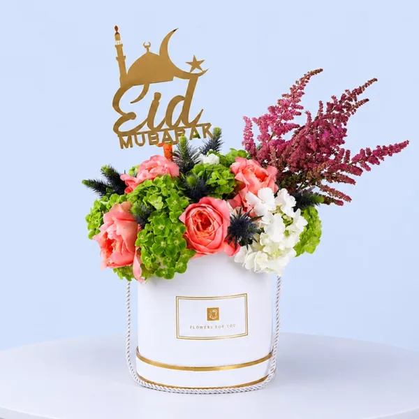 eid-floral-harmony-box Eid Floral Harmony Box featuring hydrangeas, peach roses, eryngium blue, and astilbe arranged with an Eid wishes topper for festive gifting