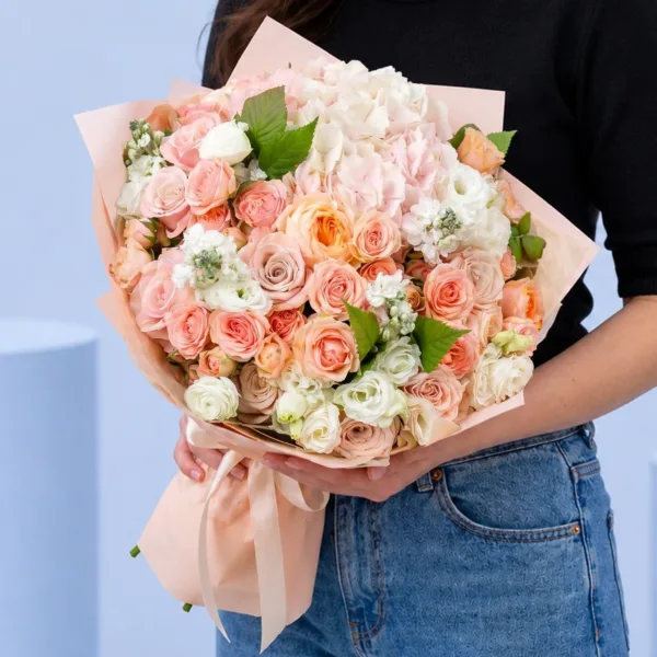 Peach Pink Harmony Bouquet featuring peach roses, light pink roses, hydrangea, lisianthus, and matthiola arranged in a soft pastel floral design