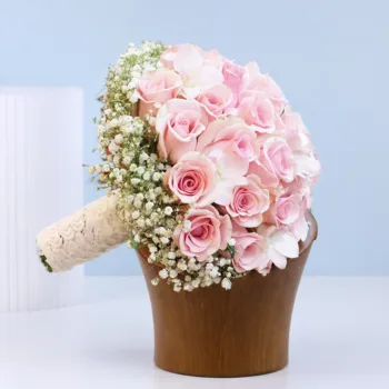 Pink Rose Bridal Bouquet featuring tightly arranged pink roses in a dome shape with baby’s breath (gypsophila) accents on the side