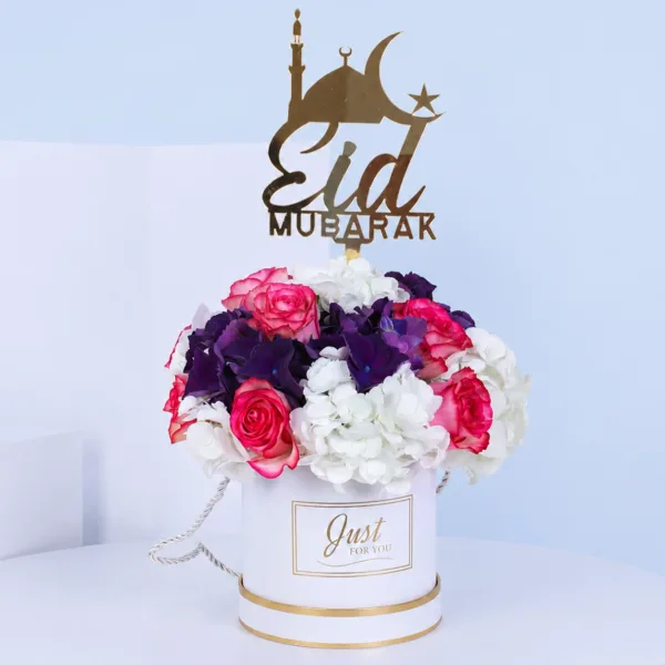 premium-eid-floral-arrangement Premium Eid Floral Arrangement featuring dual-tone roses and white and dark purple hydrangeas arranged in a personalized Eid Mubarak gift box