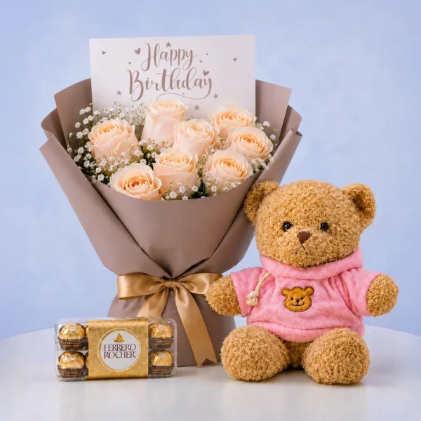 Birthday Rose Teddy Combo featuring peach roses, gypsophila, 16 Ferrero chocolates, and a 40cm pink jacket teddy bear for gifting and celebrations.