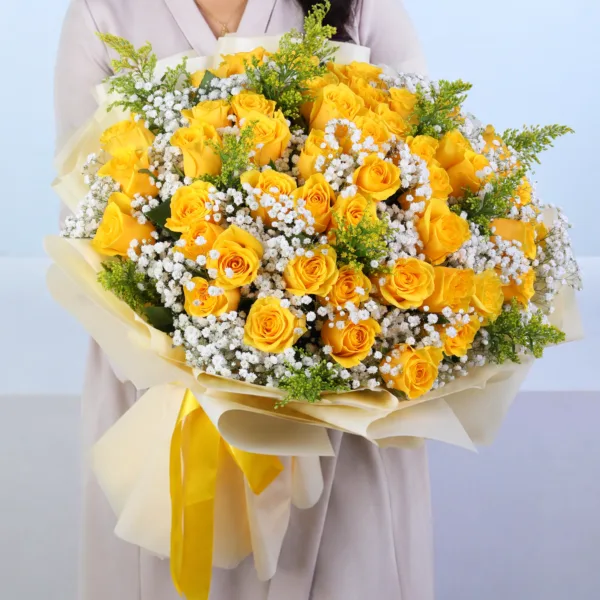 50-yellow-rose-bouquet 50 Yellow Rose Bouquet featuring 50 fresh yellow roses arranged with delicate gypsophila and lush solidaster leaves, creating a vibrant floral bouquet perfect for celebrations, birthdays, congratulations, and gifting.