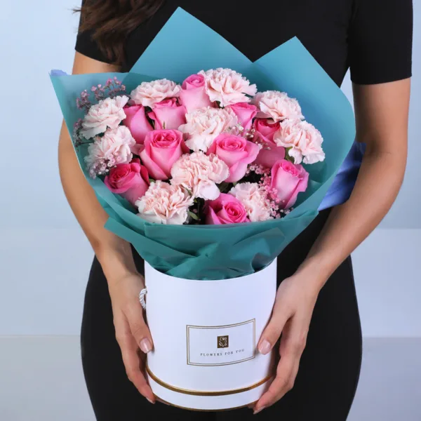 dual-rose-carnation-box Dual Rose Carnation Box featuring 10 pink roses, 10 peach carnations, and 5 stems of fresh gypsophila arranged beautifully in an elegant hat box floral arrangement.
