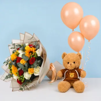 Mixed Blooms Teddy Combo featuring white, red, and yellow roses, sunflowers, eucalyptus, hypericum berries, a brown hoodie teddy bear, peach balloons, and premium floral wrapping.