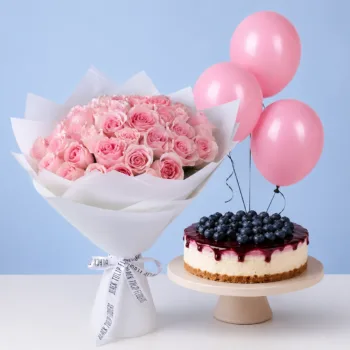 Pink Bouquet & Blueberry Cheesecake Combo featuring light pink Titanic roses, a 1 kg blueberry cheesecake, and light pink balloons for birthdays and special celebrations.