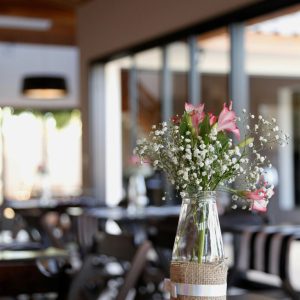 A charming centerpiece graces a table with a black and white striped runner